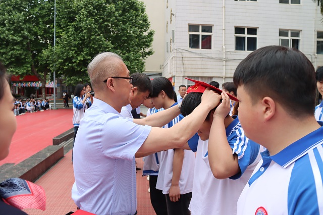 校领导为学子佩戴成人帽与成人徽章.jpg
